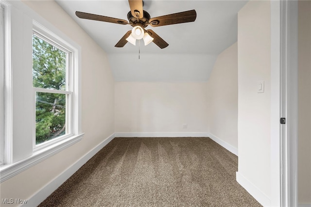 bonus room with ceiling fan, vaulted ceiling, dark colored carpet, and baseboards