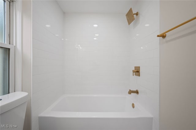 bathroom featuring toilet and bathtub / shower combination
