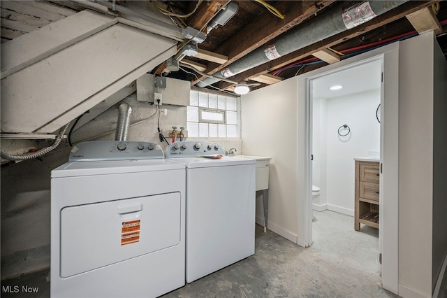 washroom featuring washer and clothes dryer and laundry area
