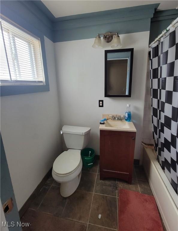 full bath featuring toilet, vanity, shower / bath combo, and tile patterned floors