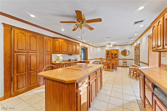 148 N Kimberly Ave N, Youngstown, OH 44515 - kitchen with ceiling fan, brown cabinets, recessed lighting, crown molding, and a center island