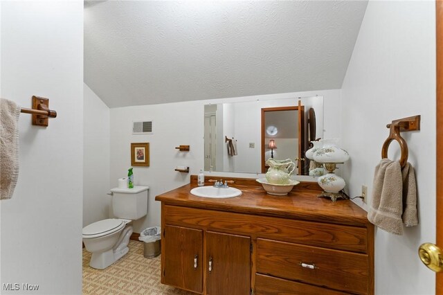 148 N Kimberly Ave N, Youngstown, OH 44515 - bathroom with vanity, lofted ceiling, a textured ceiling, and tile patterned floors