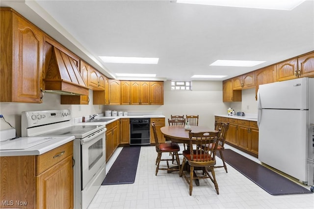 148 N Kimberly Ave N, Youngstown, OH 44515 - kitchen featuring white appliances, light countertops, light floors, and brown cabinetry
