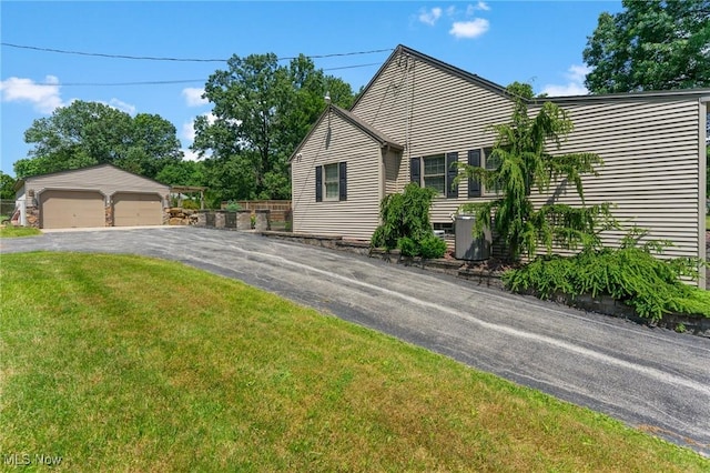 148 N Kimberly Ave N, Youngstown, OH 44515 - view of front of house with an outdoor structure, a garage, and a front lawn