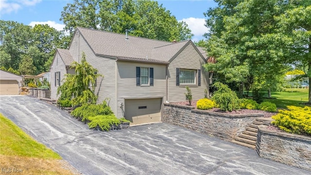 148 N Kimberly Ave N, Youngstown, OH 44515 - view of front of house with driveway, a shingled roof, and an attached garage