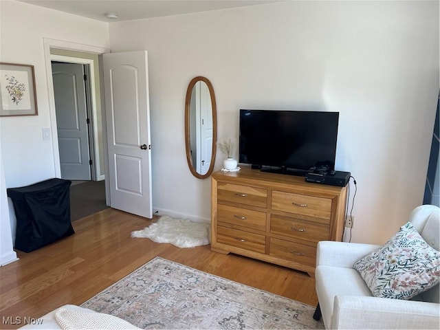 bedroom featuring baseboards and light wood-style floors