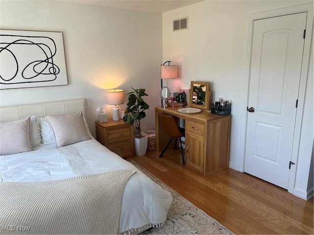 bedroom with visible vents and light wood-style floors