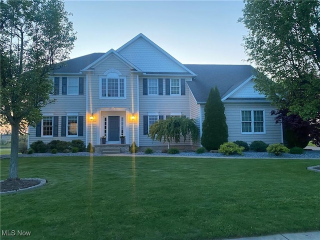 colonial home featuring a yard
