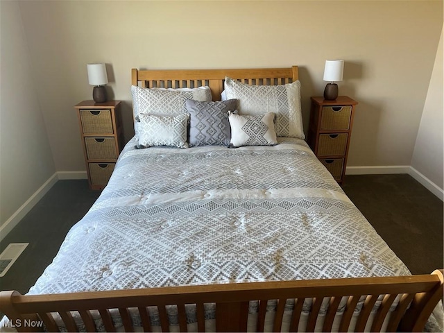 bedroom with visible vents, dark colored carpet, and baseboards