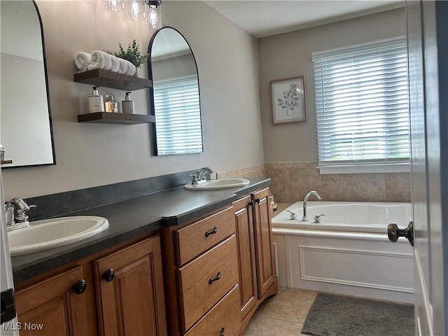 full bathroom featuring a healthy amount of sunlight, a sink, and double vanity