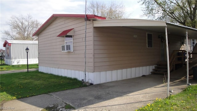 46 Navajo, Creston, OH 44217 - view of home's exterior featuring a lawn and an attached carport
