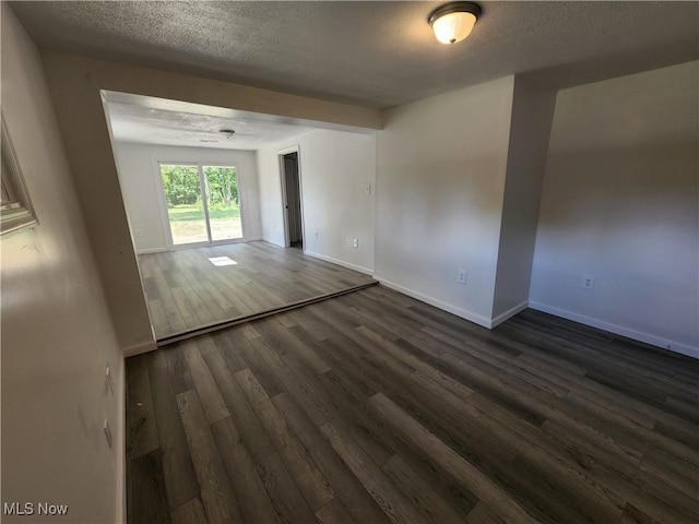 1490 Evergreen Dr, Streetsboro, OH 44241 - empty room featuring baseboards, a textured ceiling, and dark wood-type flooring