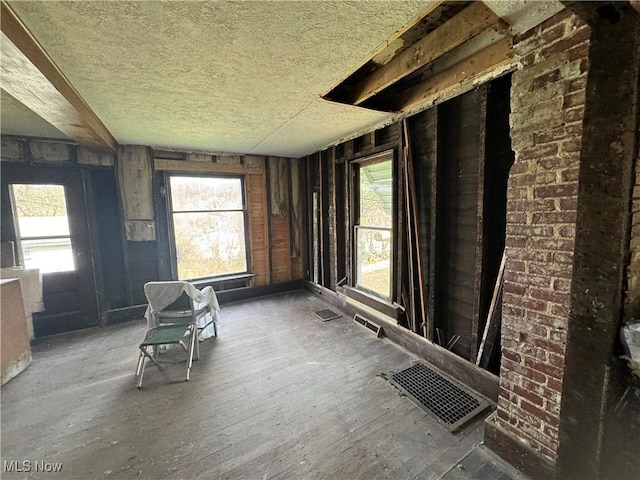 interior space featuring a wealth of natural light, visible vents, and a textured ceiling