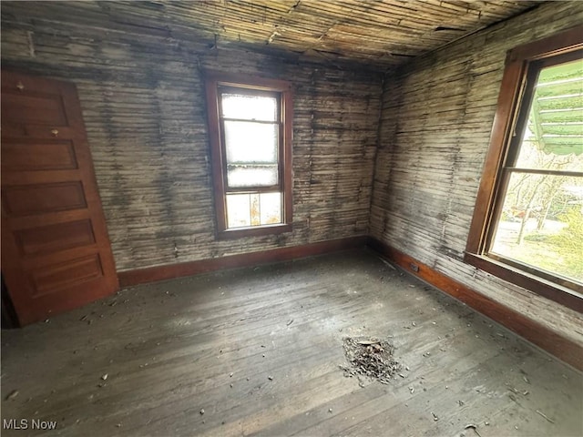 unfurnished room featuring hardwood / wood-style flooring and baseboards