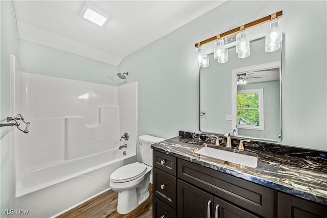 6980 Painesville Ravenna Rd, Concord, OH 44077 - bathroom with a ceiling fan, wood finished floors, vanity, shower / bath combination, and toilet