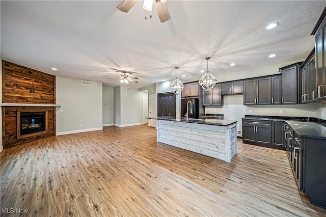 6980 Painesville Ravenna Rd, Concord, OH 44077 - kitchen with recessed lighting, open floor plan, a sink, and ceiling fan with notable chandelier