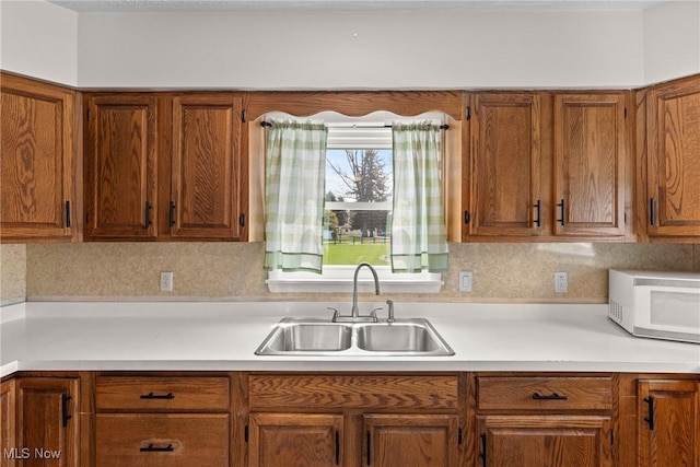 120 Hillcrest Dr, Wellsburg, WV 26070 - kitchen featuring light countertops, white microwave, brown cabinets, and a sink