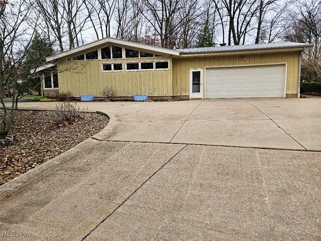 view of front of property featuring concrete driveway and a garage