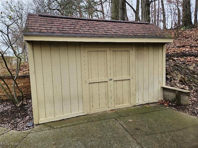 view of shed featuring fence