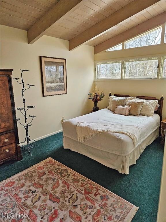 bedroom with carpet, beam ceiling, wooden ceiling, and multiple windows