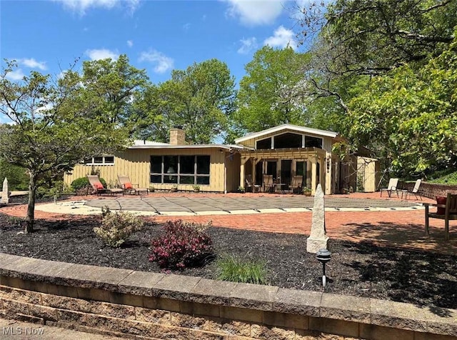 805 Lynnwood Dr, Minerva, OH 44657 - rear view of house featuring a patio and a chimney