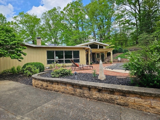 805 Lynnwood Dr, Minerva, OH 44657 - view of front of house featuring a patio area and a chimney