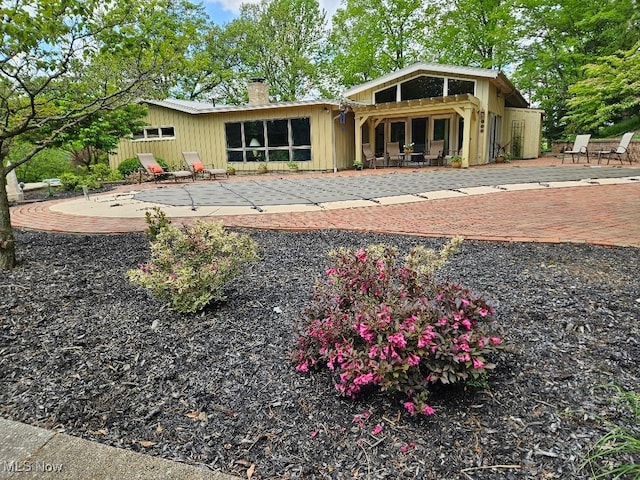 805 Lynnwood Dr, Minerva, OH 44657 - back of house featuring a patio area and a chimney