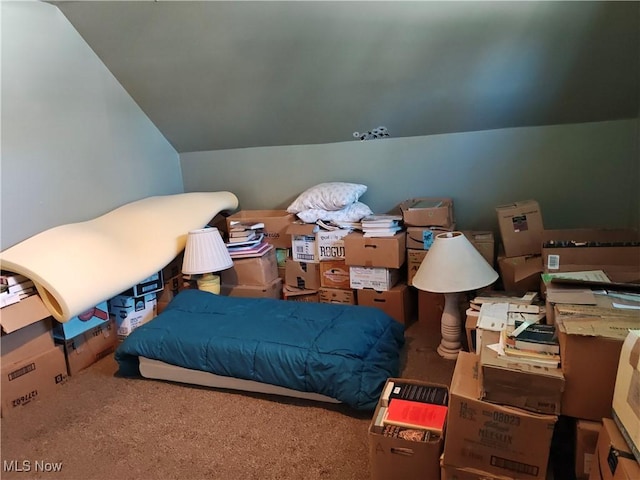 bedroom featuring lofted ceiling and carpet