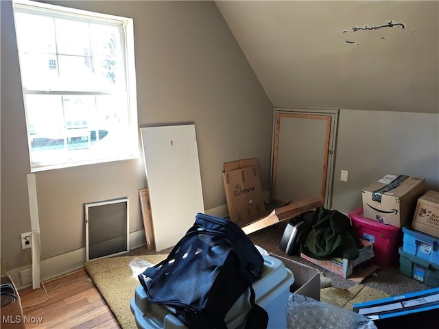 additional living space featuring lofted ceiling and wood finished floors