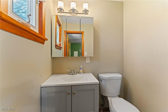 bathroom featuring toilet and vanity