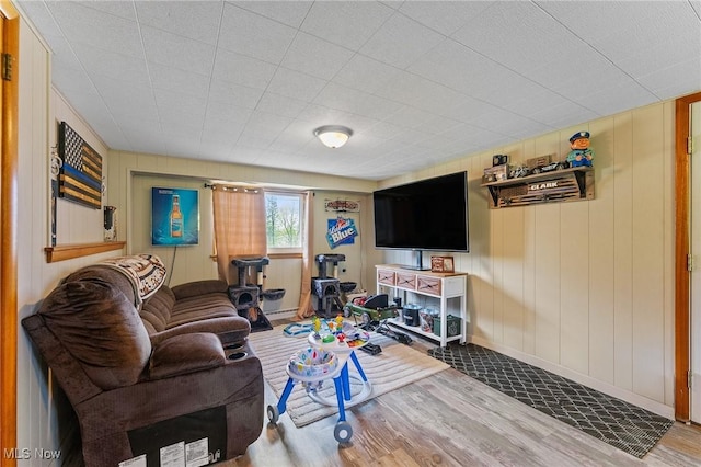 living area featuring baseboards and wood finished floors