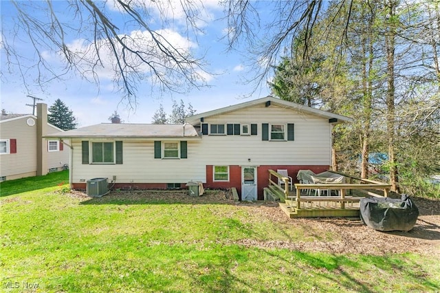 rear view of house featuring a lawn, central AC, and a deck