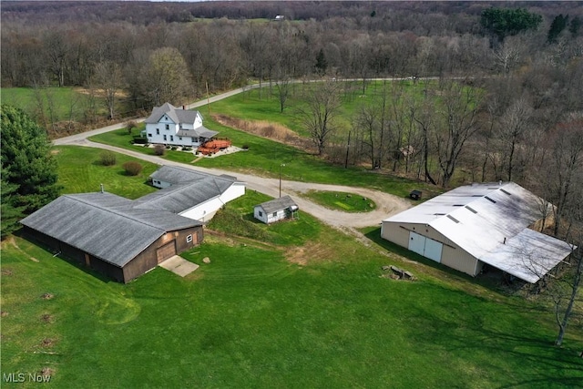 drone / aerial view featuring a wooded view
