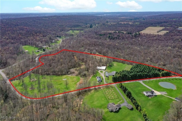 birds eye view of property with a forest view and a rural view