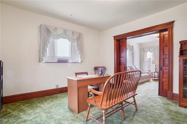 carpeted home office featuring baseboards