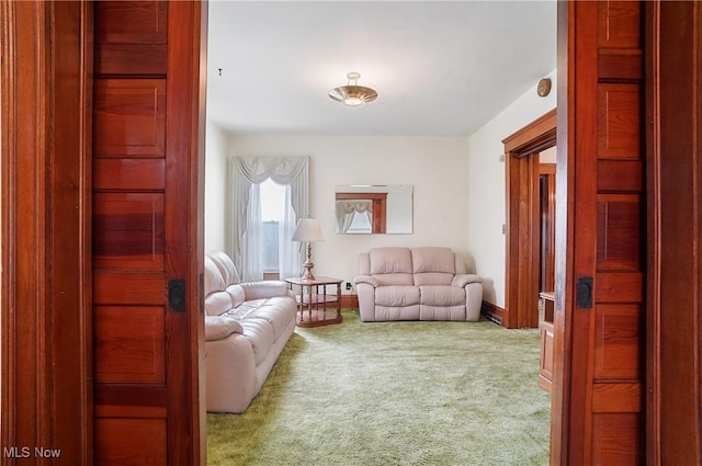sitting room with baseboards and carpet