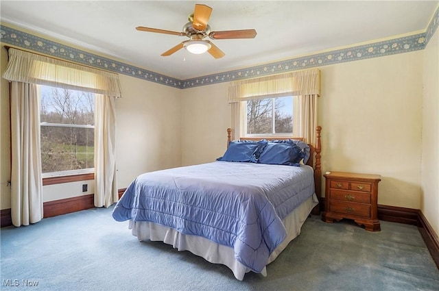 carpeted bedroom featuring a ceiling fan and baseboards