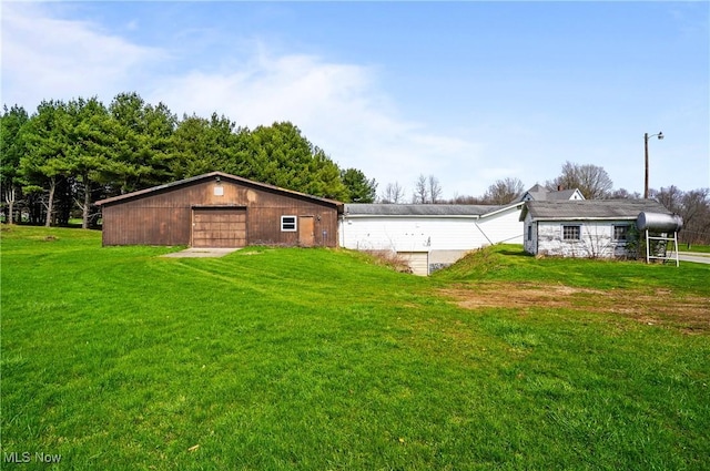 exterior space with an outdoor structure and a detached garage