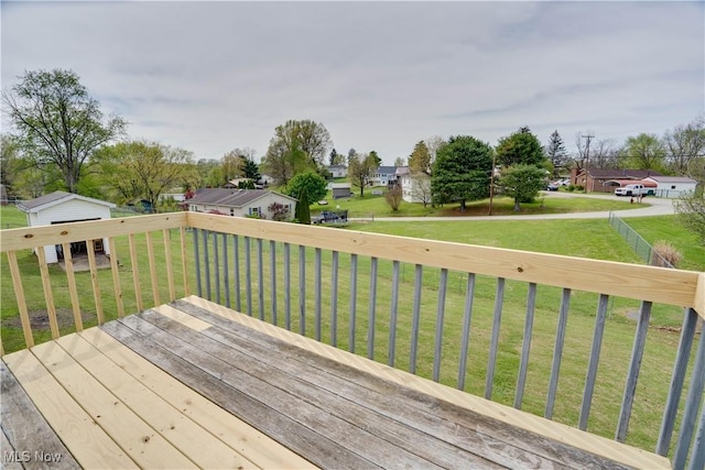 wooden deck featuring a lawn and a residential view