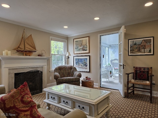 living room featuring recessed lighting, carpet, a premium fireplace, crown molding, and baseboards