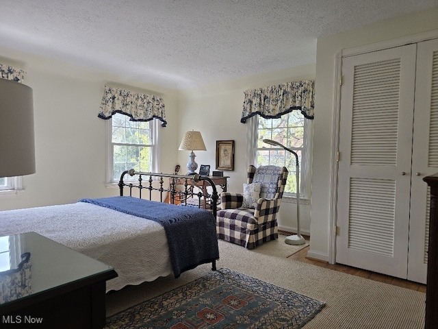 bedroom featuring a textured ceiling and a closet