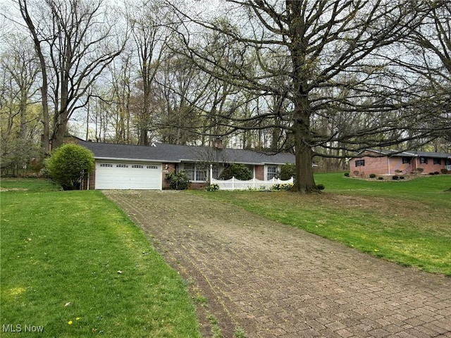 2476 Willow Brook Dr NW, Dover, OH 44622 - single story home featuring a chimney, aphalt driveway, an attached garage, fence, and a front yard