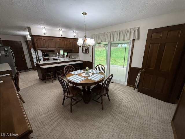 2476 Willow Brook Dr NW, Dover, OH 44622 - dining area with a textured ceiling and a notable chandelier