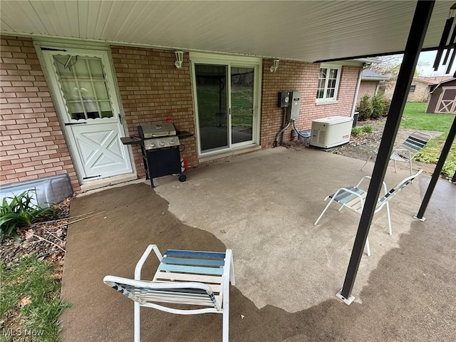 2476 Willow Brook Dr NW, Dover, OH 44622 - view of patio featuring a storage shed, a grill, and an outdoor structure
