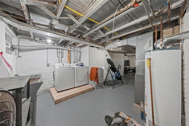 unfinished basement featuring water heater and independent washer and dryer