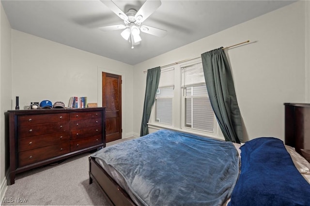 bedroom featuring ceiling fan, baseboards, and carpet flooring