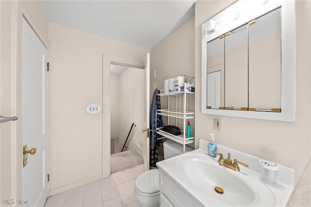bathroom featuring toilet, vanity, and tile patterned floors