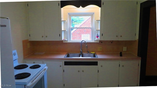 2 W Haywood Blvd, Struthers, OH 44471 - kitchen with white range with electric cooktop, light countertops, white cabinets, and a sink