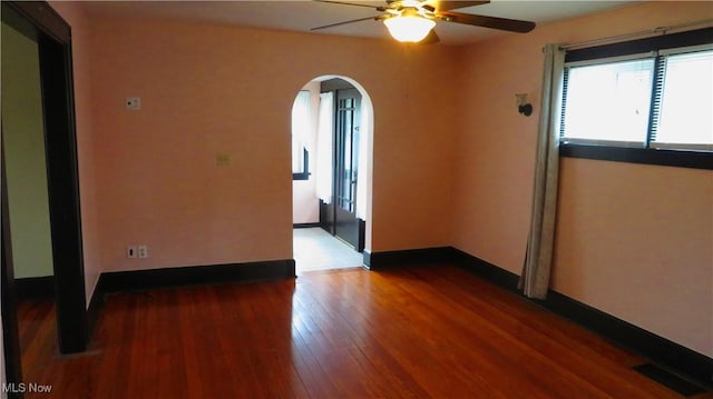 2 W Haywood Blvd, Struthers, OH 44471 - unfurnished room featuring a ceiling fan, visible vents, baseboards, arched walkways, and wood finished floors