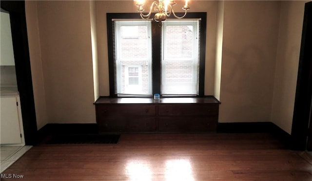 2 W Haywood Blvd, Struthers, OH 44471 - empty room with wood finished floors and a chandelier